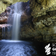 Smoo Cave waterfall with Scottish Geology Trust logo in white