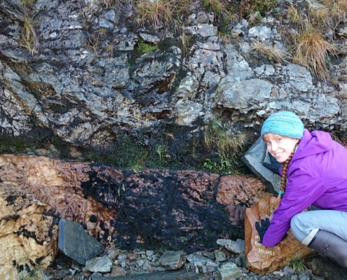 Dr Laura Hamlet places her hands either side of the Moine Thrust.