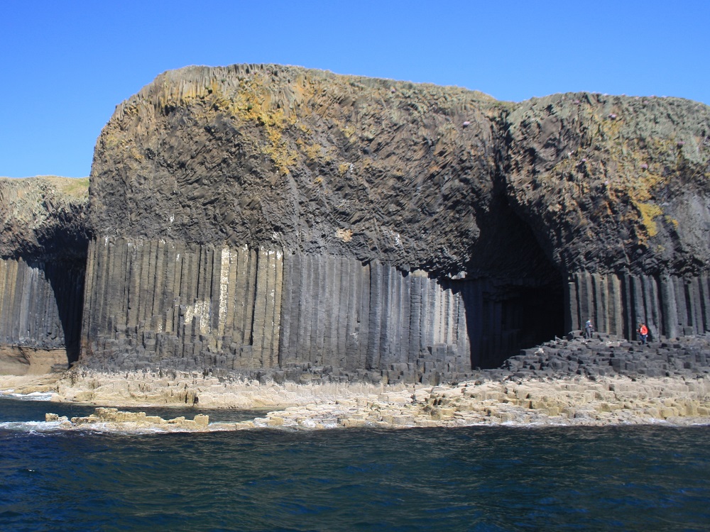A general view of Staffa and Fingal’s Cave, showing the columnar structure, the cave and the underlying pyroclastic rocks.