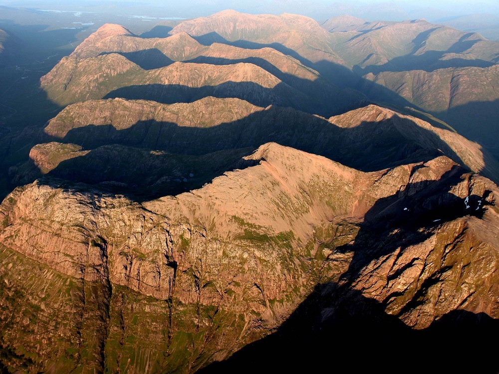 Glen Coe, a glaciated, mountain landscape, photograph taken over the ‘Three Sisters of Glen Coe’, with the arête ridge of Aonach Dubh in the foreground.