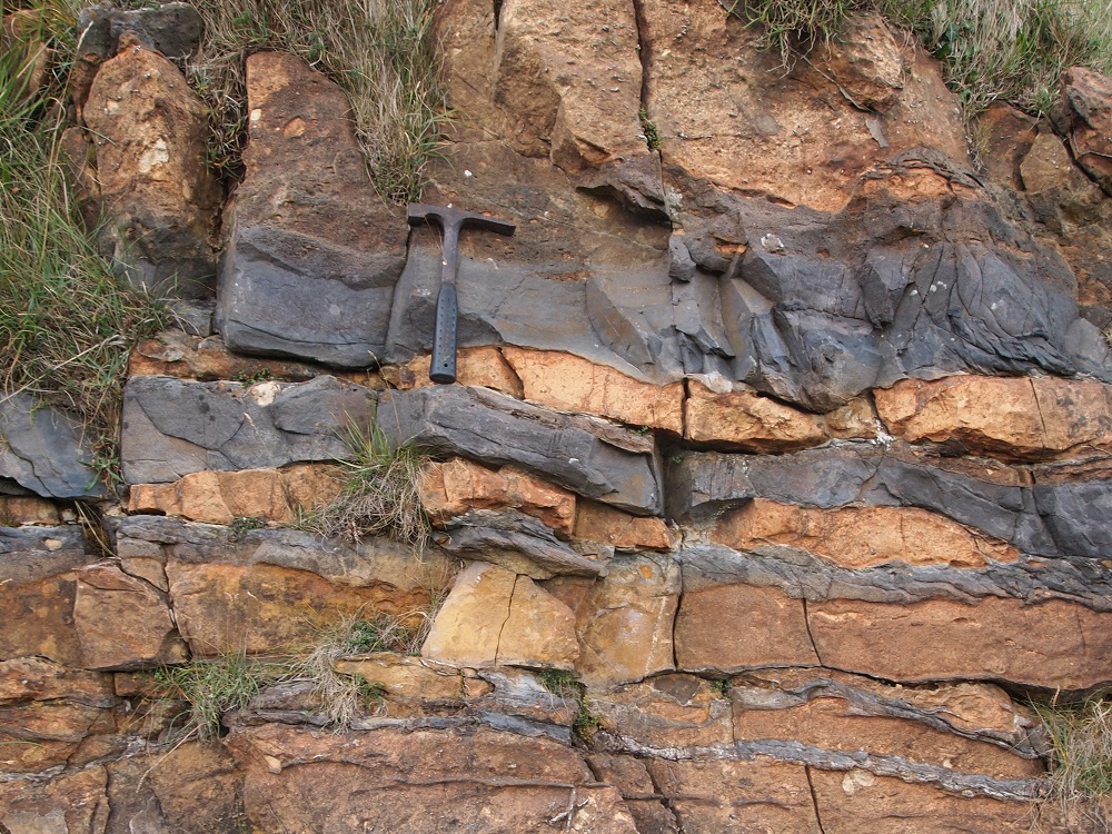 Bedded iron-rich sandstones, concretionary dolostones and sandy dolomitic diamictites (the ‘Disrupted Beds’) in the lower part of the Port Askaig Tillite at Beannan Buidhe near Ballygrant, Islay.