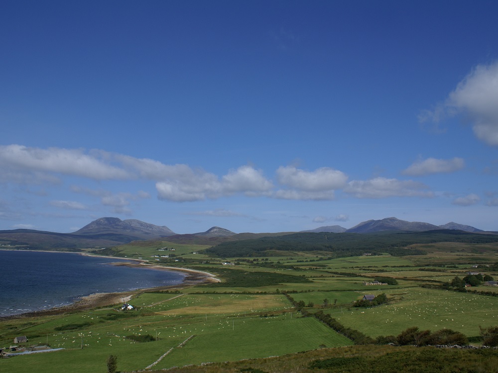 Fertile lowlands of Arran with the northern granite mountains in the distance.